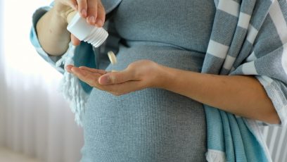 Pregnant woman taking pills.