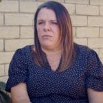 A woman is sitting and giving a testimonial about how good the Watts Trial Firm is. Small picture